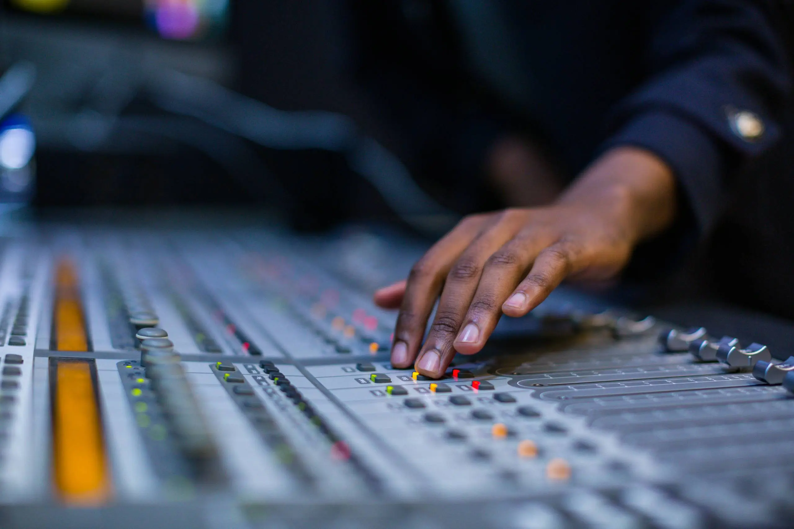 Hands on a mixing console